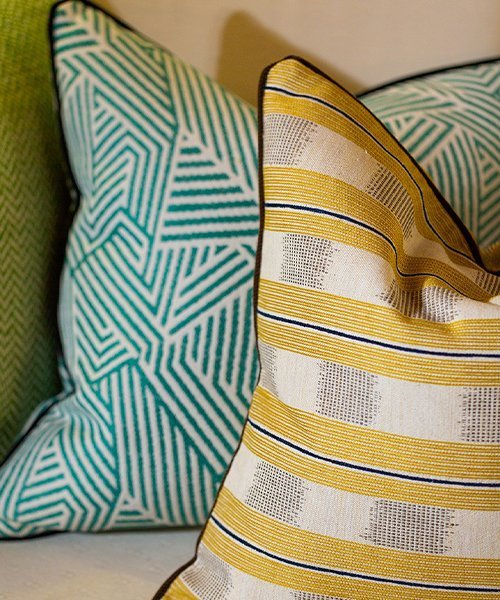 Two cushion covers in a warmer palette