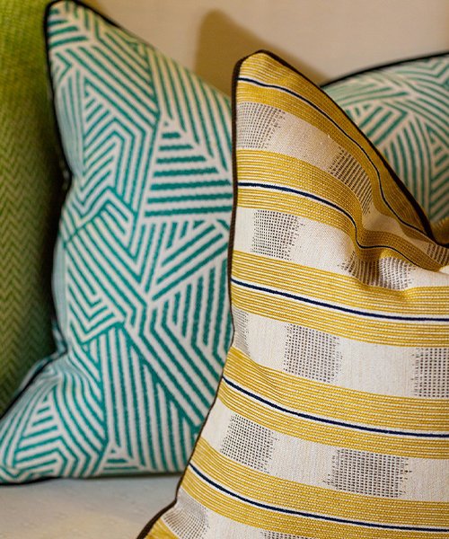 Two cushion covers in a warmer palette